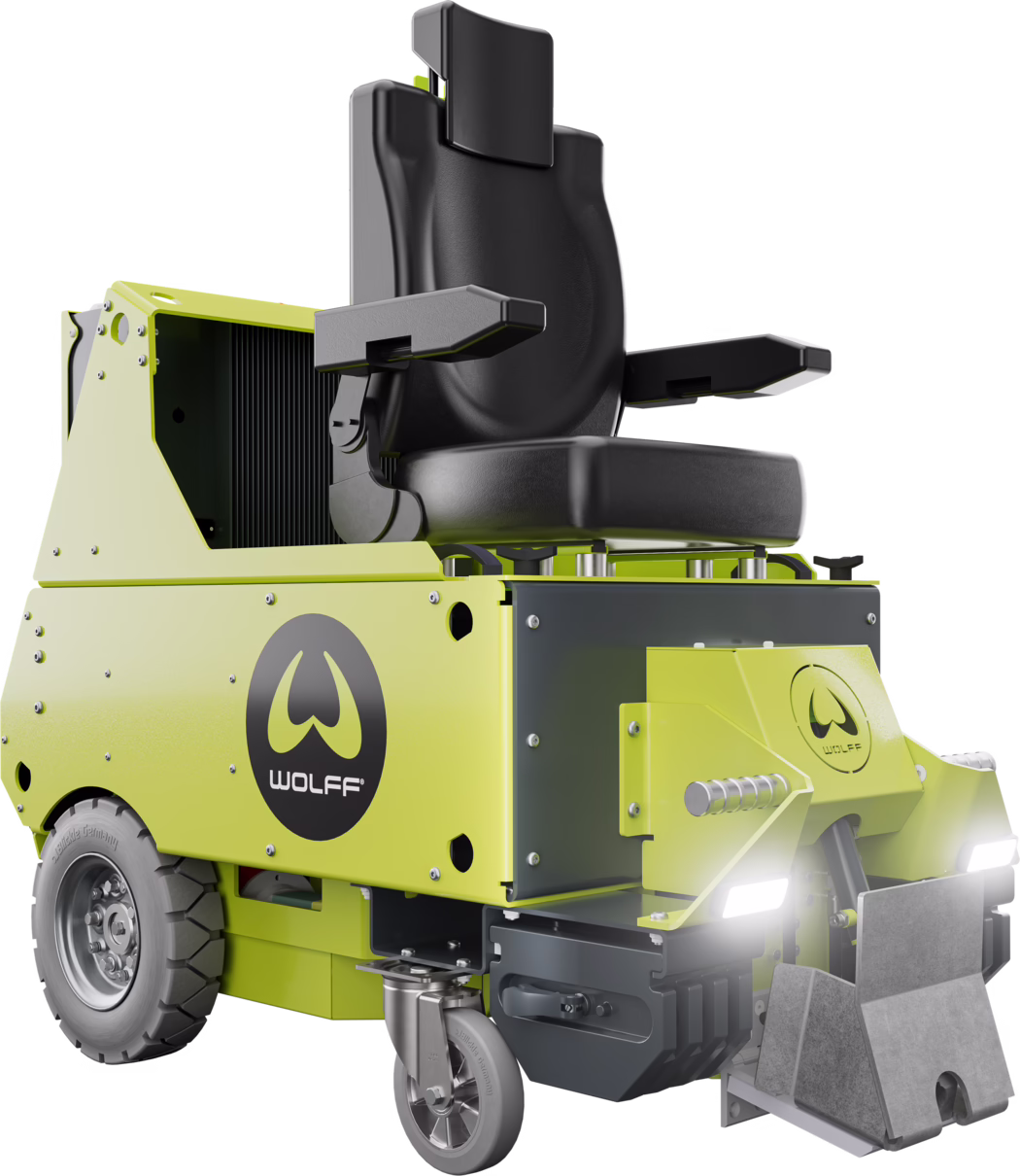 WOLFF_Dummy_168801_Independence_20222025-08 A compact lime-green ride-on industrial floor sweeper with a black padded driver's seat, armrests, and a high backrest. Visible front headlights, a small caster wheel at the front, large rear tire, and a metal brush/collector assembly at the front. WOLFF logo on the side panel. Studio product photo on a white background showing rivets, bolts and painted metal panel details.